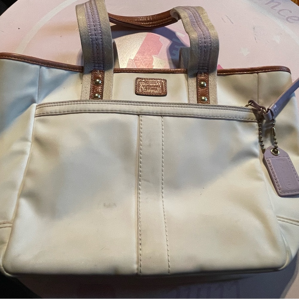 White and lavender coach pocketbook